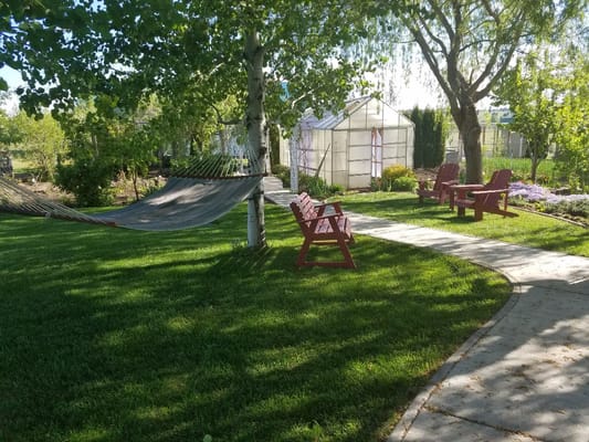 Tranquil outdoor garden space with seating and hammocks