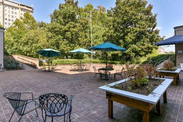 Outdoor patio area with tables and umbrellas