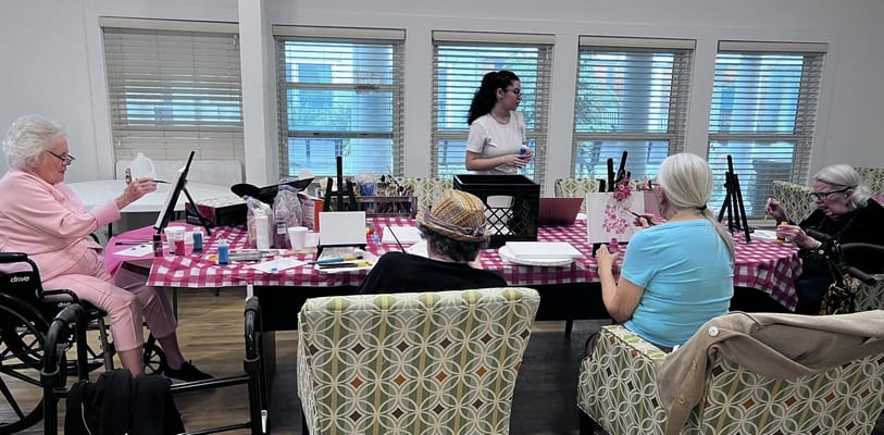 Residents participating in a craft activity indoors