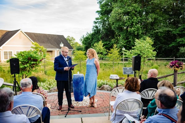 Outdoor event with a speaker and attendees present