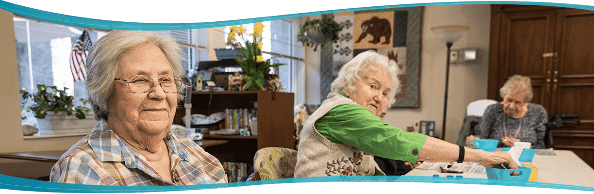 Residents enjoying activities in a bright common area