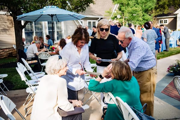 Residents and staff engaging in conversation outdoors