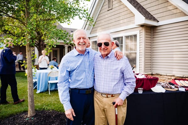 Two residents smiling at an outdoor event