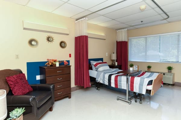 Cozy private resident room with bed and furnishings