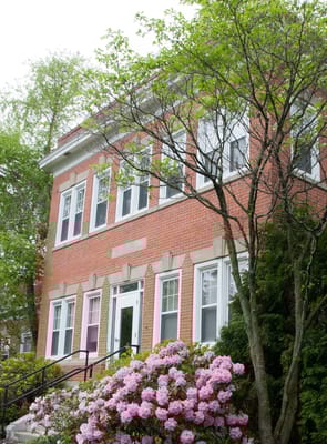 Exterior view of a red brick building with flowers