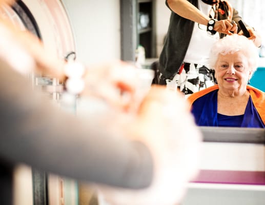 Resident getting a haircut in a salon setting