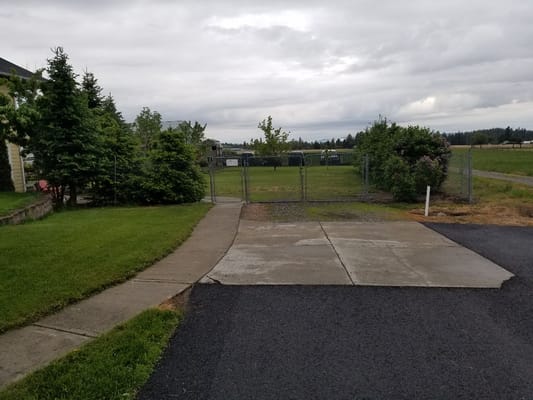 Outdoor space with a fenced area and grass