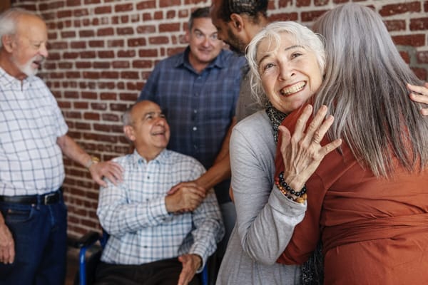 Residents and staff enjoying a warm gathering in a common area