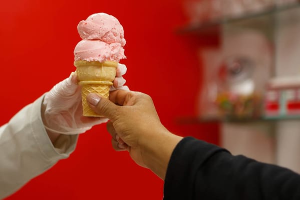 Staff serving ice cream to a resident