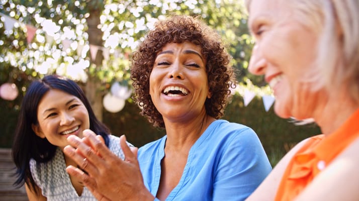 Three women laughing and enjoying time outdoors