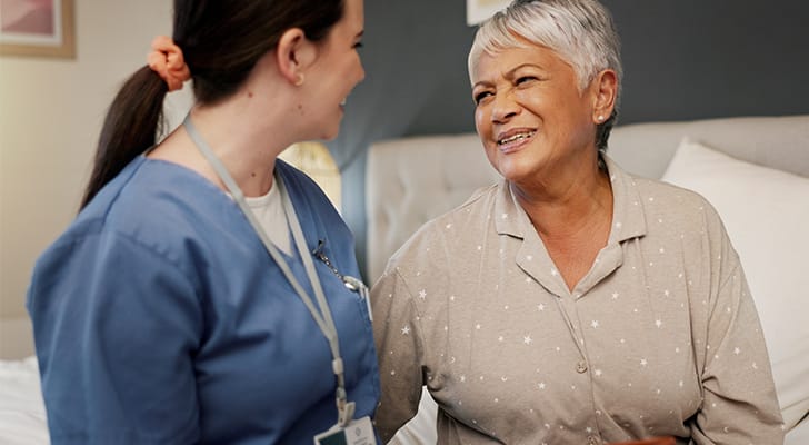 A caregiver and a resident sharing a joyful moment