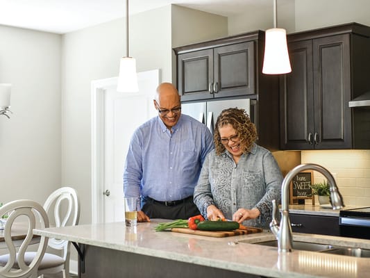 Two residents cooking together in a modern kitchen