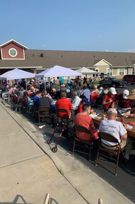 Residents and staff enjoying an outdoor event with tents