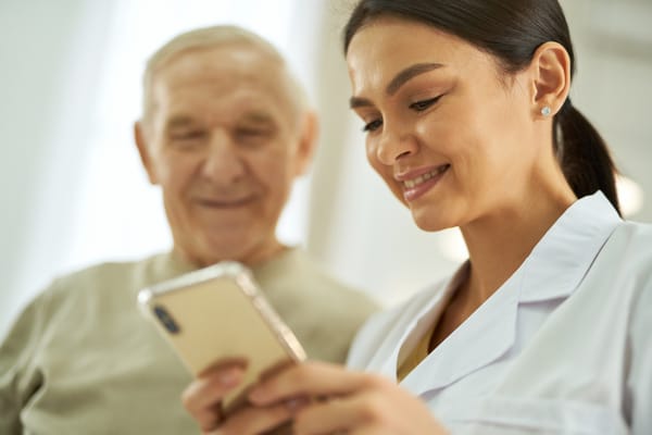 Caregiver and resident engaging with a smartphone