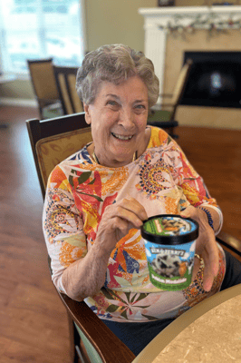 Senior resident enjoying ice cream in a common area