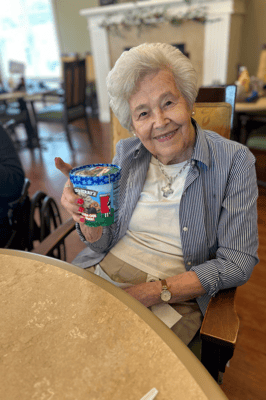 Resident enjoying a colorful drink in the common area