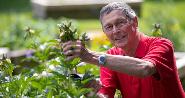 Resident gardening in a vibrant outdoor area