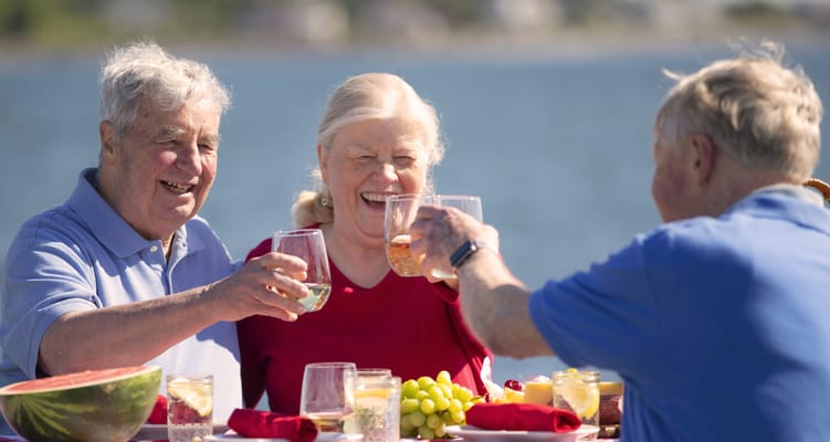 Residents celebrating with drinks by the water