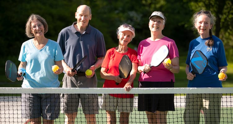 Residents enjoying a game of pickleball outdoors