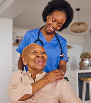 A caregiver smiling while assisting a resident