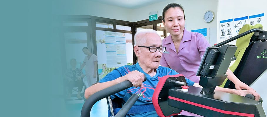 Staff assisting a resident with exercise equipment