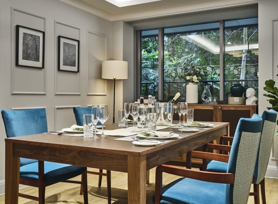 Well-lit dining area with tables and chairs