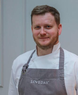 Chef wearing an apron in a kitchen setting