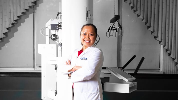 A staff member posing confidently in a medical setting