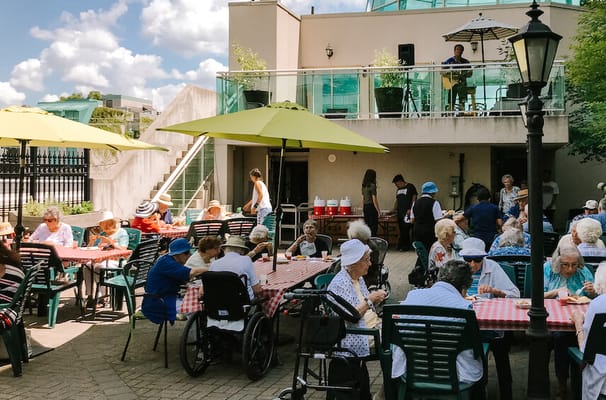 Residents enjoying a meal outdoors on a sunny day