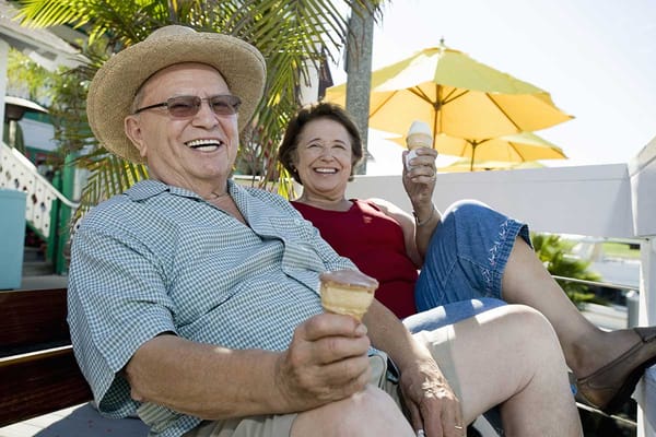 Two residents enjoying ice cream outdoors on a sunny day
