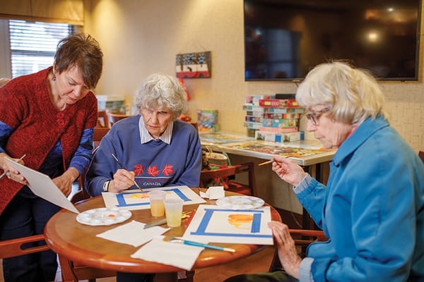 Residents engaged in an art activity in a common area