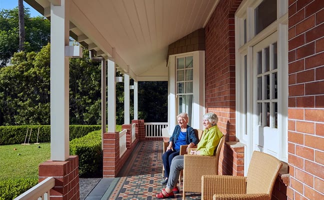 Two residents enjoying time on the porch