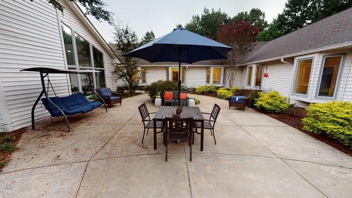 Outdoor patio area with seating and umbrella