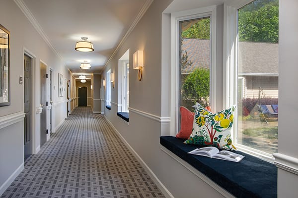 Bright hallway in a senior living facility with decor