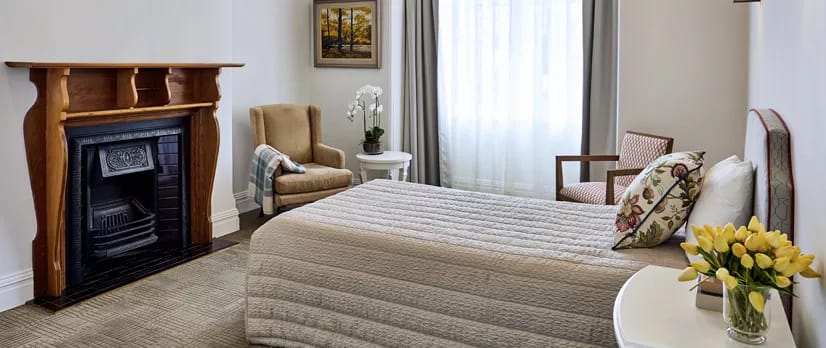 Cozy resident room with a bed and seating area