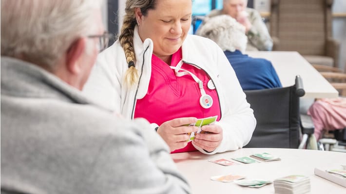 Staff member engaging with a resident in an activity