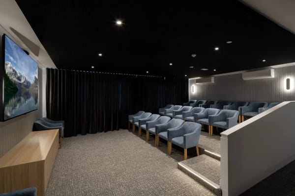 Interior theater room with seating and large screen