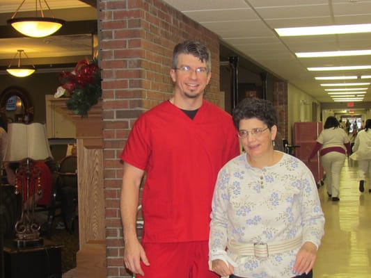 Staff member assisting a resident in the hallway