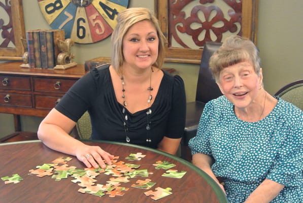 Residents and staff engaged in a puzzle activity