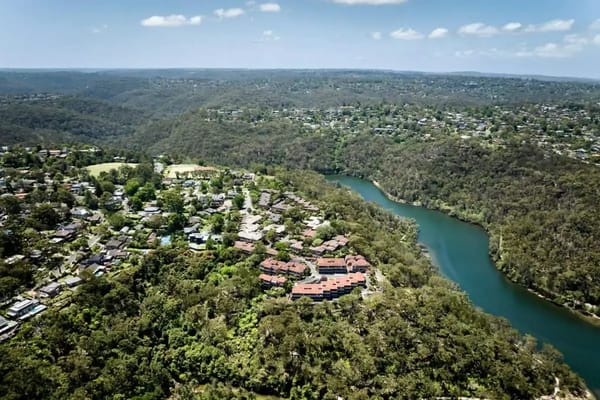 Aerial view of a senior living campus surrounded by nature