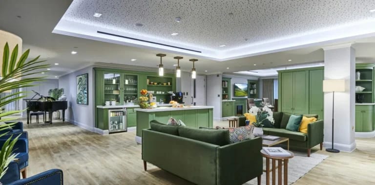 Bright common area with seating and piano