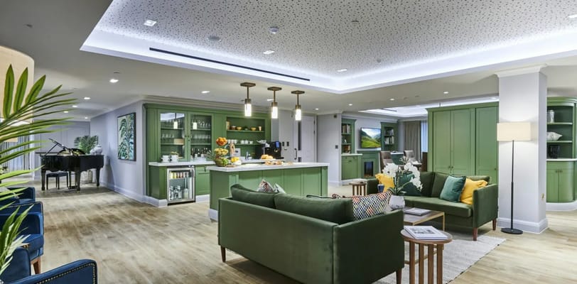 Bright common area with seating and piano