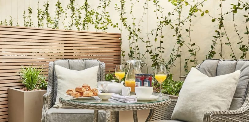 Outdoor seating area with breakfast and drinks