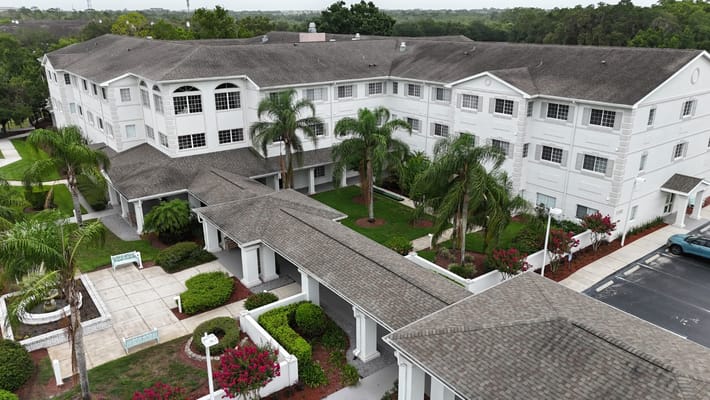 Aerial view of The Bridge at Orlando senior living facility with landscaped grounds and pathways.