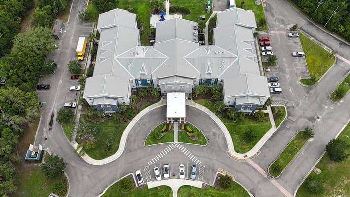 Aerial view of The Landings at Gentry Park senior living facility with surrounding parking and landscaping.