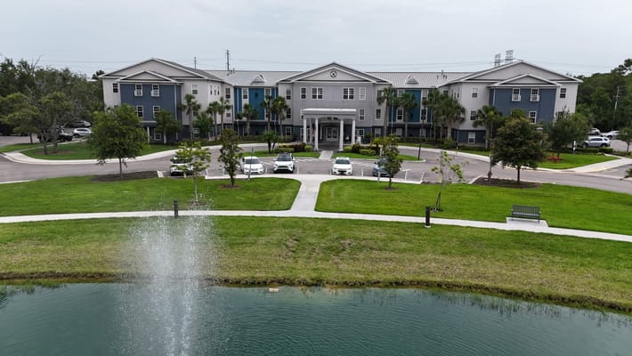 Exterior view of The Landings at Gentry Park featuring landscaping and parking area