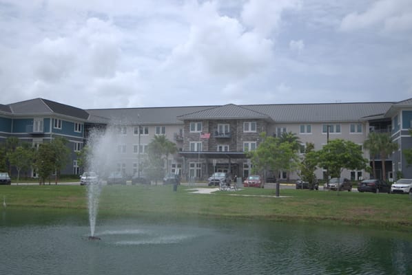 The Landings at Gentry Park building with a fountain in the foreground