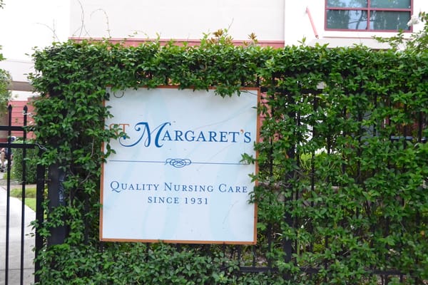 St. Margaret's facility sign surrounded by greenery