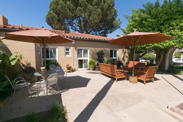 Outdoor seating area with umbrellas and plants