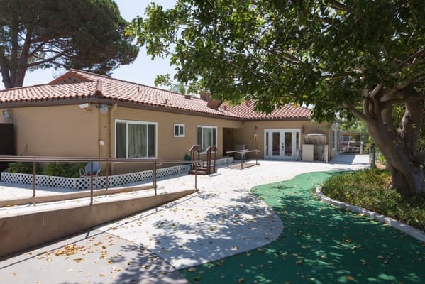 Outdoor view of a nursing center building with a path